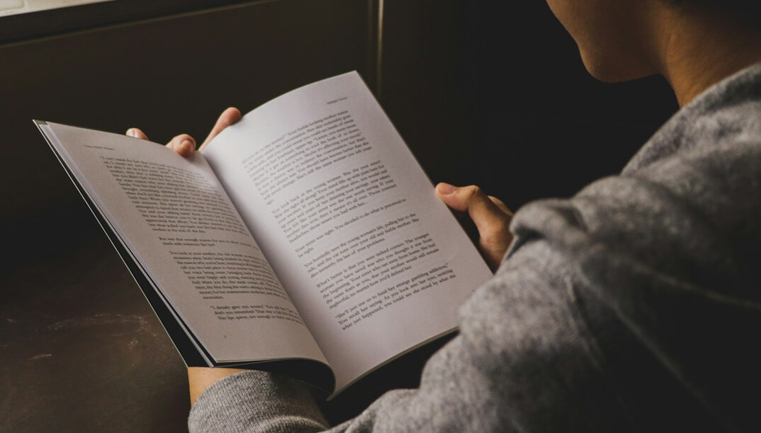 person reading book in quiet room