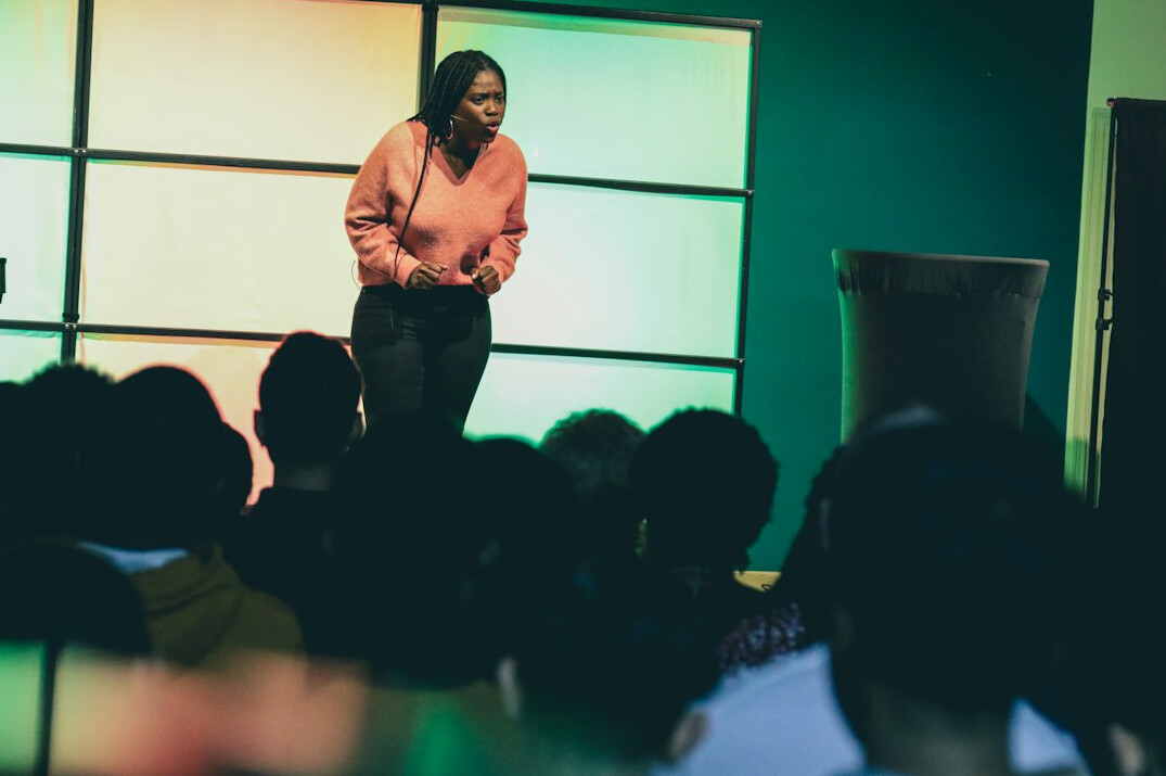man giving speech on stage