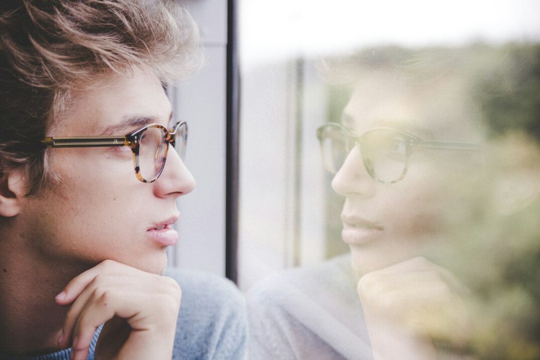 person looking at mirror thoughtfully